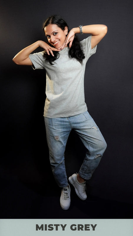 A cute woman wearing unisex round neck long length short sleeved misty grey t-shirt, posing elegantly highlighting a up to the minute easygoing fit-Muselot