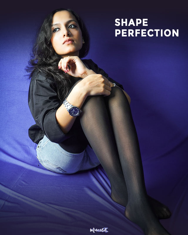A model wearing flattering black stockings that perfectly accentuate her shape- Muselot