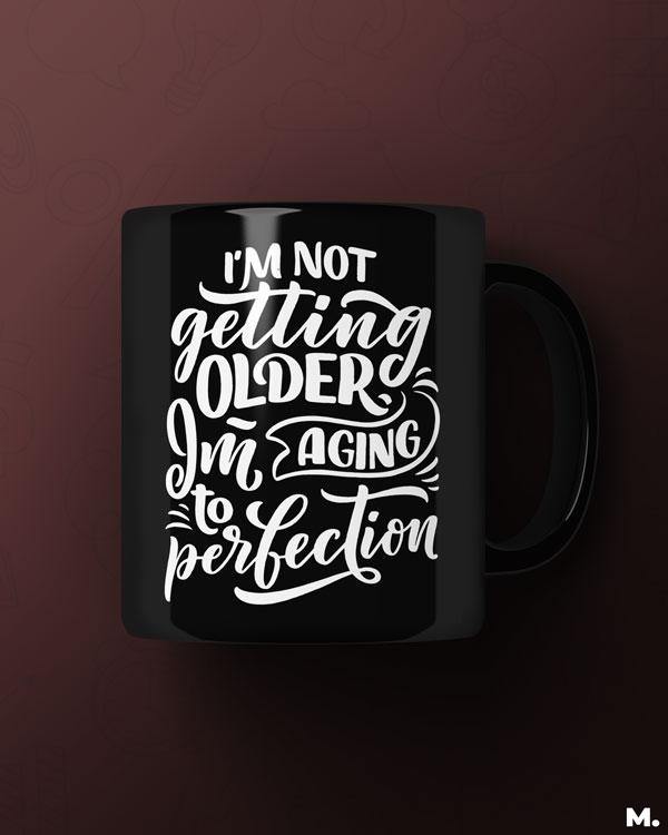 Black printed mugs online for moms - I am aging to perfection - MUSELOT