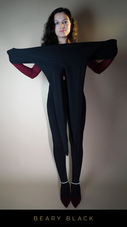 A model is stretching the warm black tights, showcasing their flexible, body-hugging fit that adapts to larger sizes for maximum comfort-Muselot