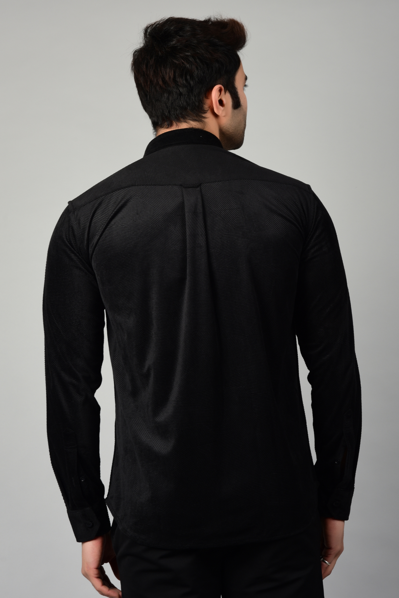 A back view of a black shirt, showcasing the seamless fit and smooth nature of the fabric-Muselot