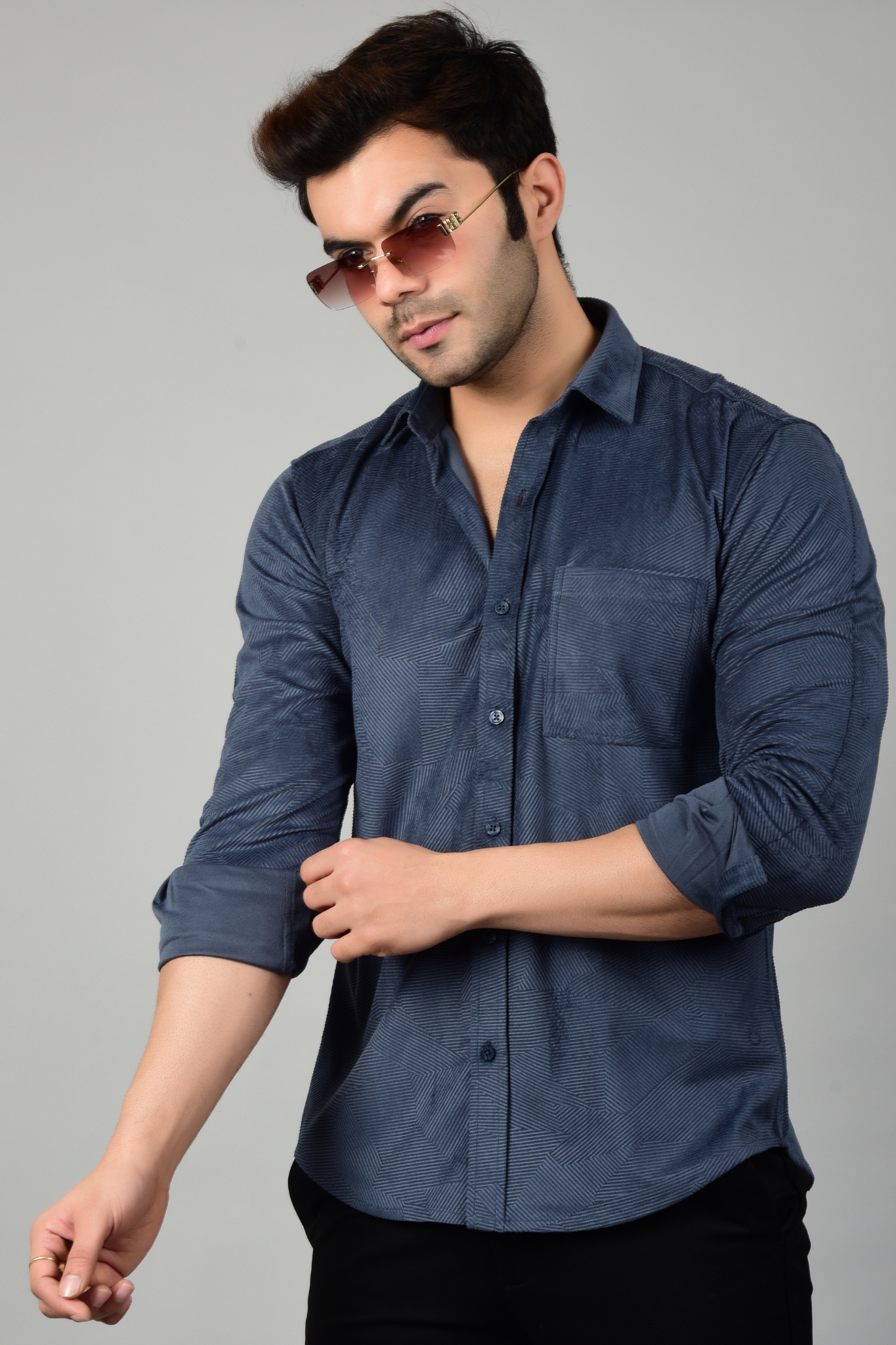 A model posing with a rolled up sleeves,showcasing a stylish look-Muslet