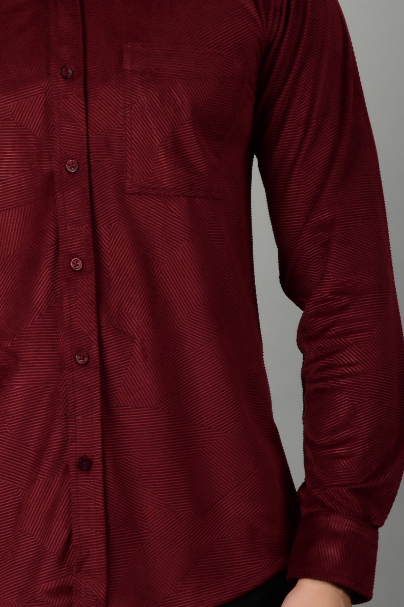 A close up view of a maroon shirt, highlighting the texture of the shirt-Muselot