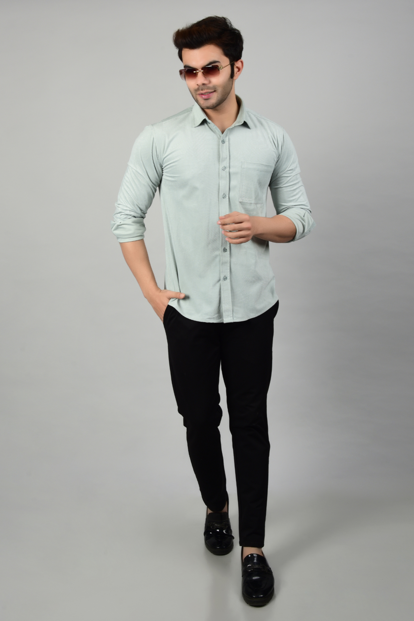 Model pairing sky shirt with black pants and sunglasses, highlighting stylish appearance of the shirt-Muselot