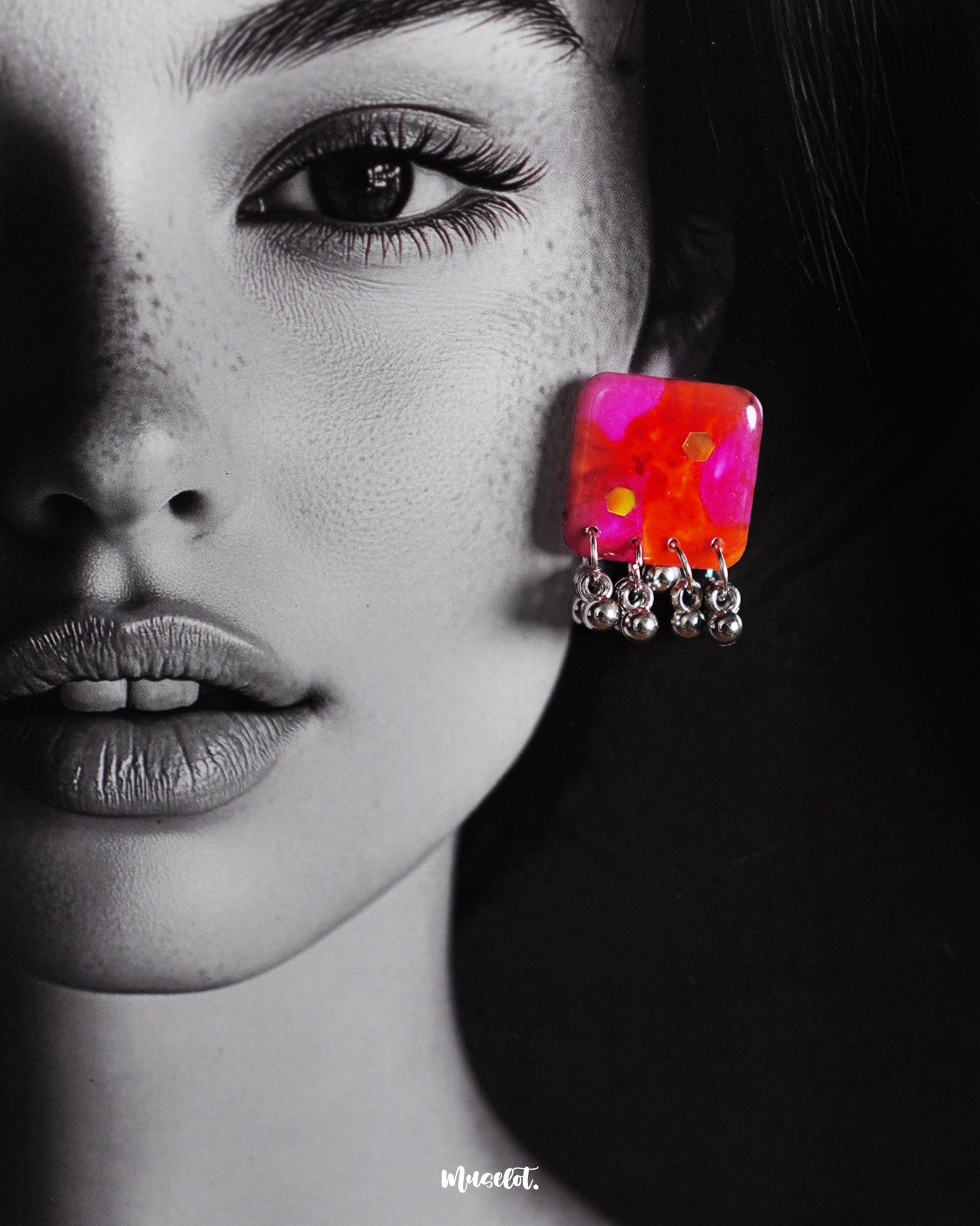Close-up shot of a model wearing the Aynoor pink floral earrings from the jewelry set, with soft pink floral accents and fine detailing that beautifully enhance the elegance of the design — Muselot.