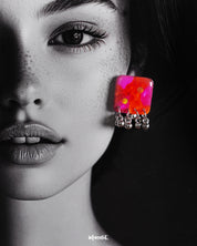 Close-up shot of a model wearing the Aynoor pink floral earrings from the jewelry set, with soft pink floral accents and fine detailing that beautifully enhance the elegance of the design — Muselot.