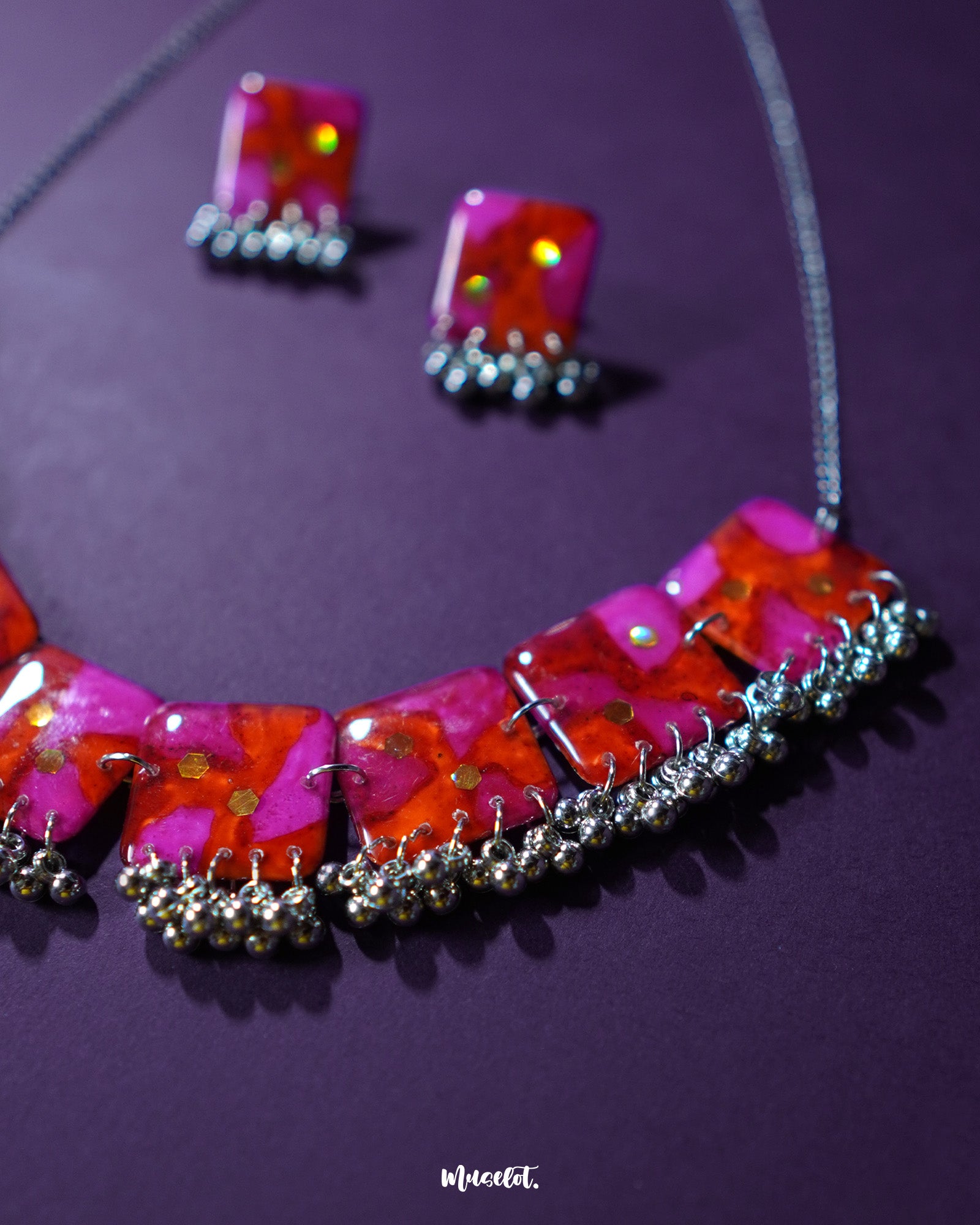 Aynoor pink floral jewelry set, set against a rich purple background, with soft pink floral accents and intricate detailing that bring out the elegance and charm of this delicate design — Muselot.