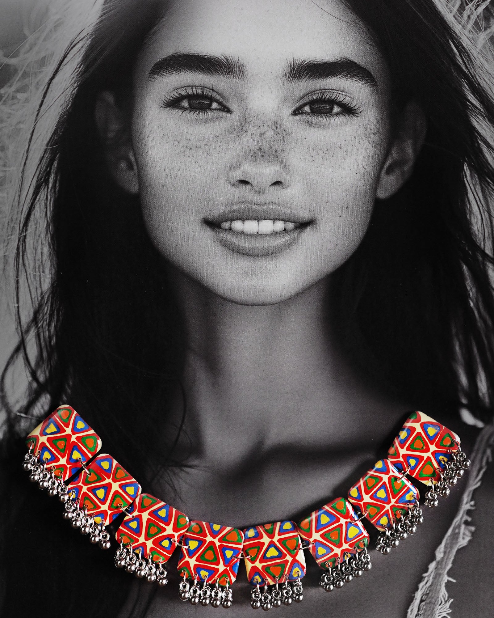 a model wearing the Bandhani handmade necklace, with intricate designs and vibrant hues that enhance the traditional charm and sophisticated appeal of the piece — Muselot.