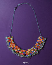 Bandhani handmade necklace, set against a soft backdrop, featuring intricate Bandhani patterns and vibrant colors that bring out a traditional yet elegant charm — Muselot.