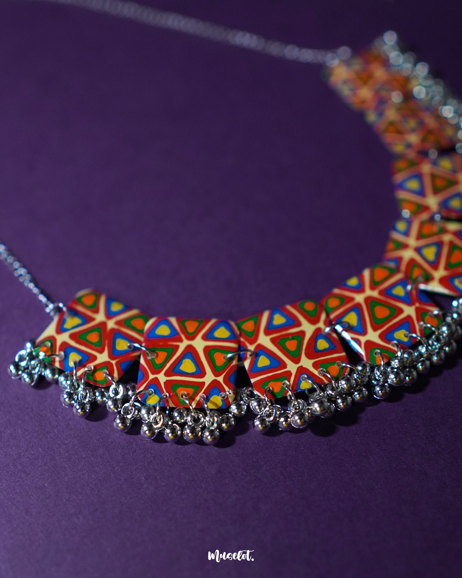 Bandhani handmade necklace, highlighted against a neutral backdrop, with vibrant tie-dye patterns and intricate craftsmanship that bring out its bold, traditional appeal and artistic elegance — Muselot.