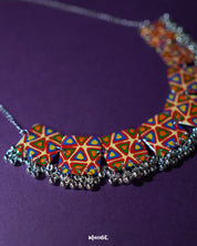 Bandhani handmade necklace, highlighted against a neutral backdrop, with vibrant tie-dye patterns and intricate craftsmanship that bring out its bold, traditional appeal and artistic elegance — Muselot.