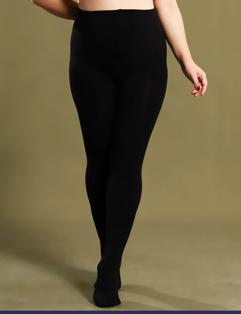 A plus-size woman in black thermal tights showcasing their smooth texture and snug, comfortable fit - Muselot