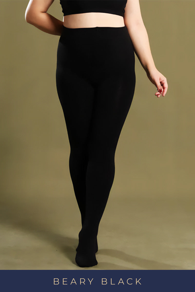 A plus-size woman in black thermal tights showcasing their smooth texture and snug, comfortable fit - Muselot