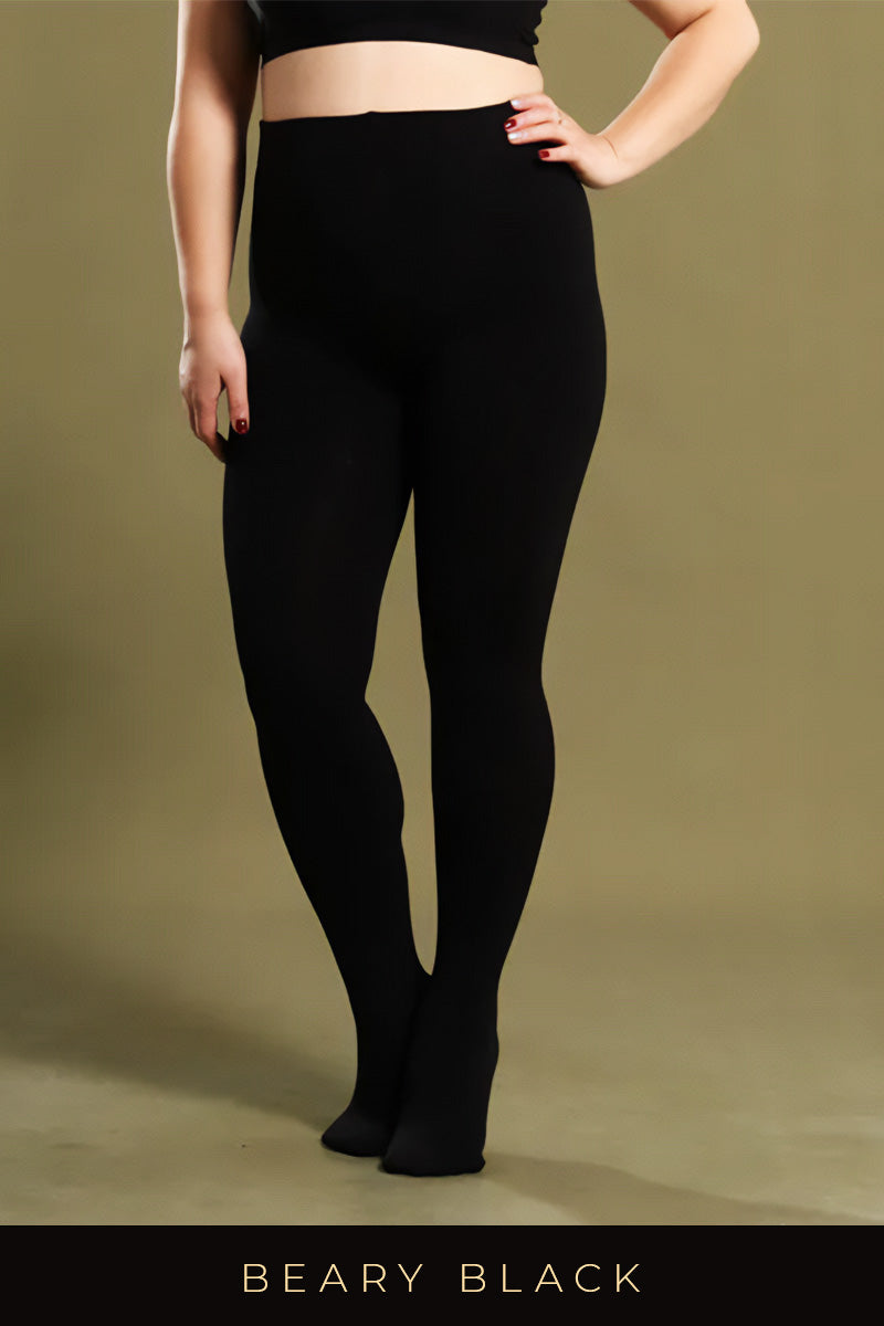 A plus-size woman in black thermal tights against an olive background, highlighting their smooth and comfortable fit - Muselot