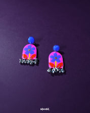Benazir floral earrings elegantly placed against a soft purple backdrop, featuring intricate purple flowers and bold red leaves that exude a charming, artistic flair — Muselot