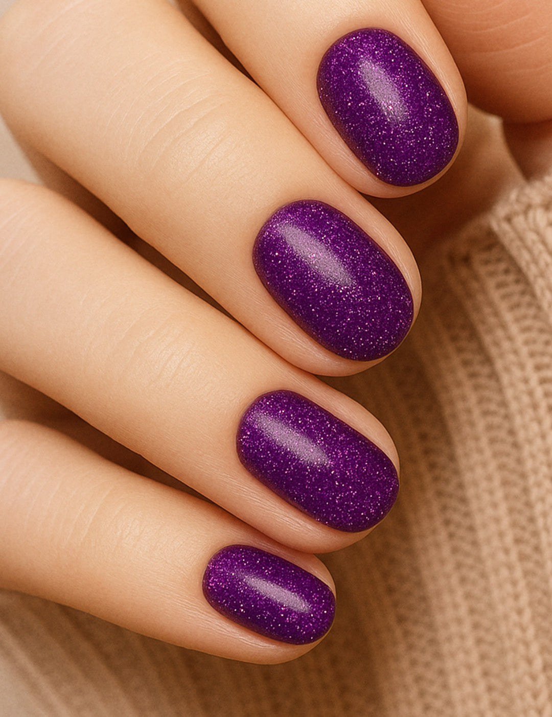 A model hand styled with Berry Cosmos Glitter nail stickies, showcasing a deep purple base lit up with tiny pink, blue, and violet sparkles. The look highlights the galaxy-like shine and bold elegance of this cosmic-inspired glitter manicure – Muselot.