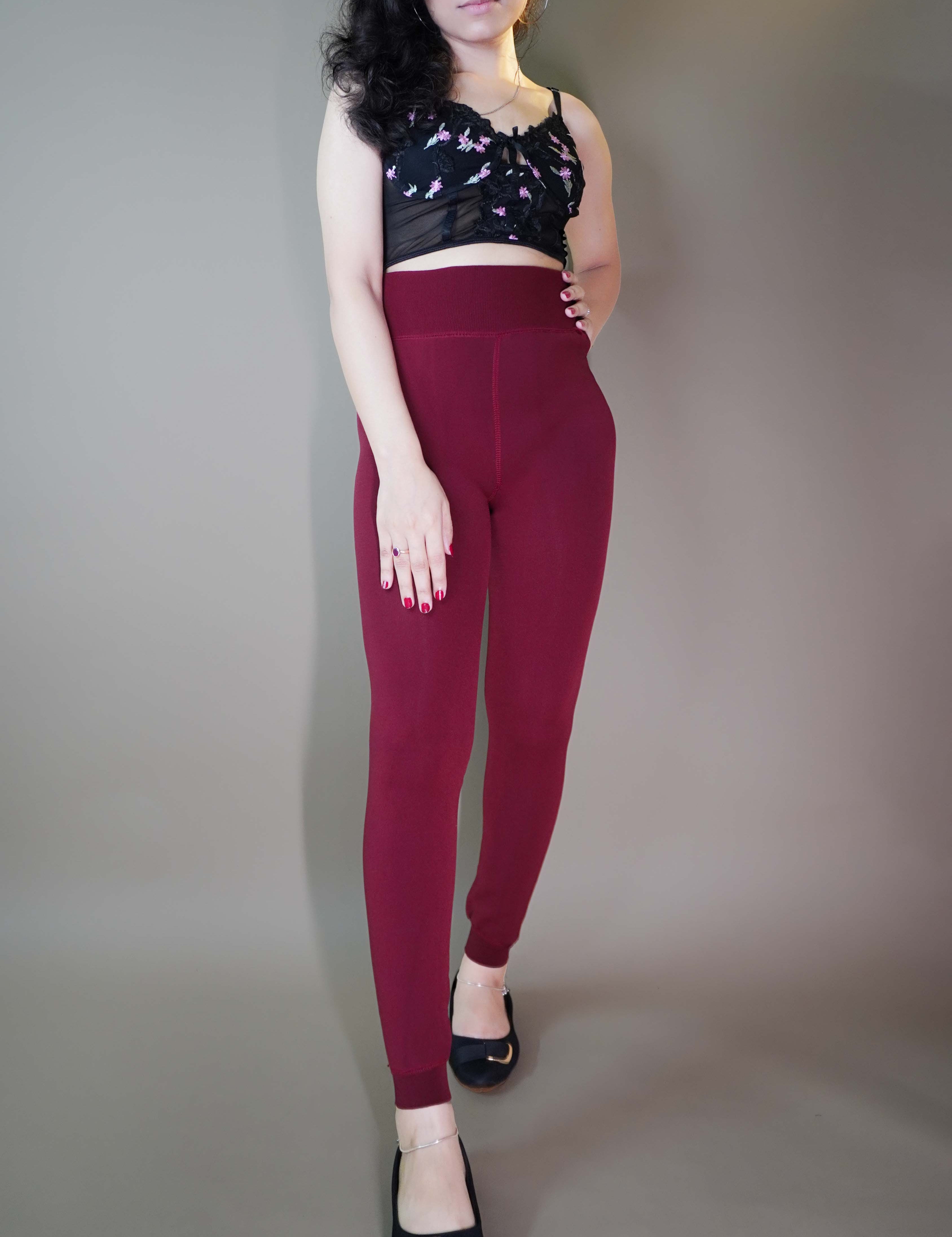 A model, wearing berry maroon warm stockings, highlighting their rich, deep color combined with a soft, insulating fabric. The stockings provide both warmth and style, adding a cozy, vibrant touch to any outfit. -Muselot