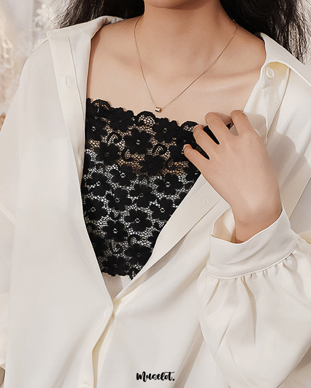 A woman wearing a black lacy mocker featuring delicate lace detailing, adding a subtle statement to her outfit with its elegant and refined finish — Muselot.
