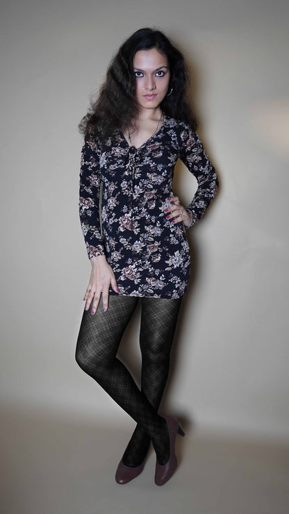 A woman wearing sheer stocking in pattern design for girls, posing with her hand on her waist and other on her thigh as she looks confidently at the camera, showcasing the voguish sexy look-Muselot