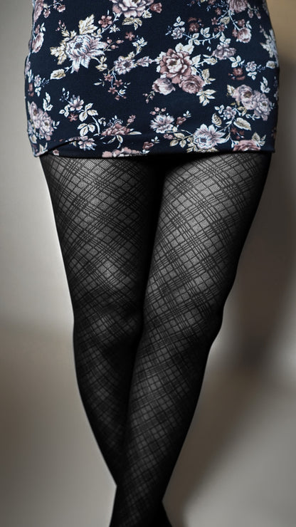 A close-up of the lower part of a model wearing lattice black stretchable patterned pantyhose, highlighting the smooth tear proof stockings-Muselot