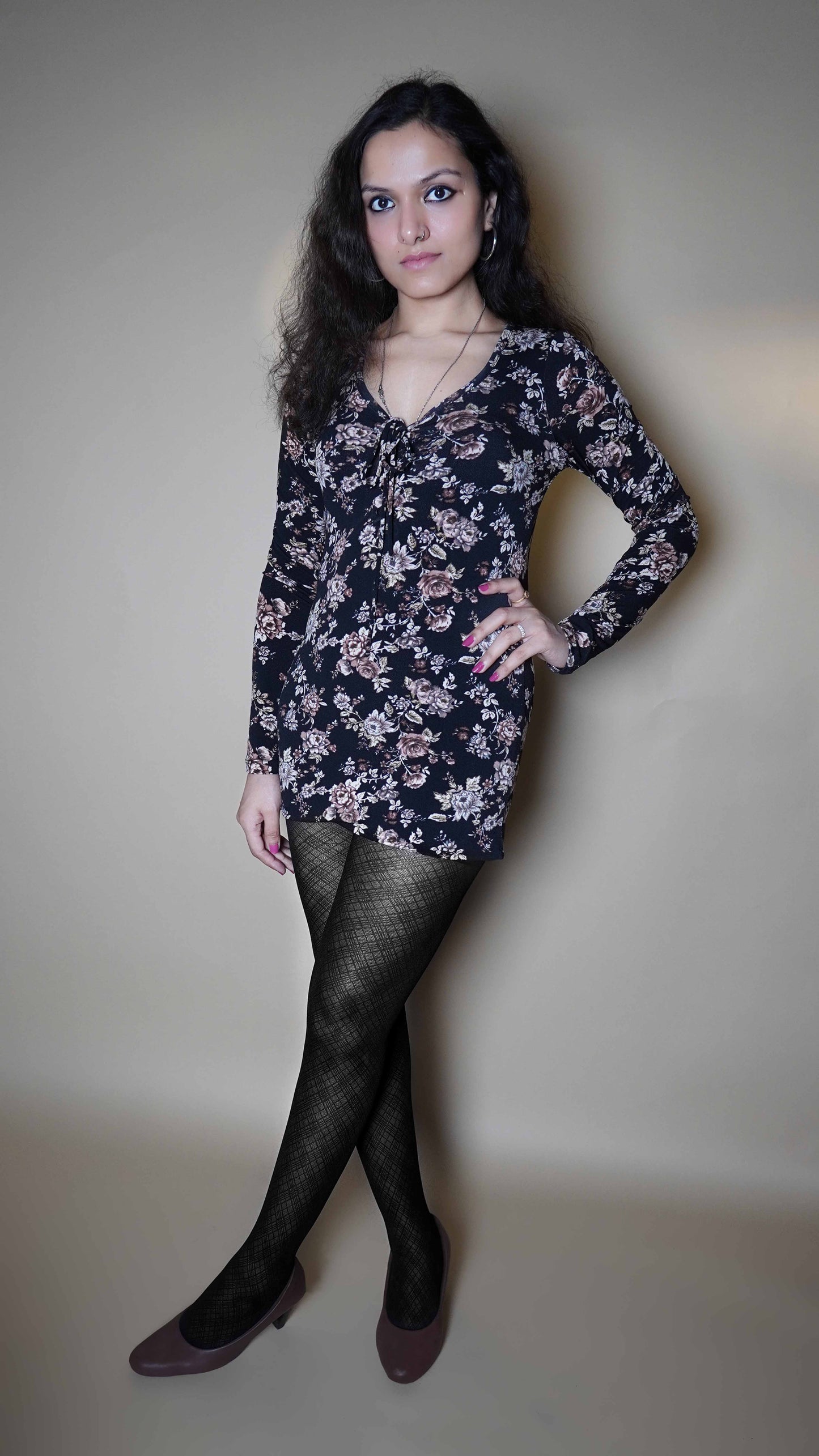 A woman wearing black patterned stretchable stocking, posing with her hand on her waist and other hanging on her side, showcasing the modish trendy look-Muselot