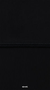 Macro close-up of black semi-opaque breathable tights with reinforced seam, showing fine ribbed texture, strength, and high-quality finish - Muselot
