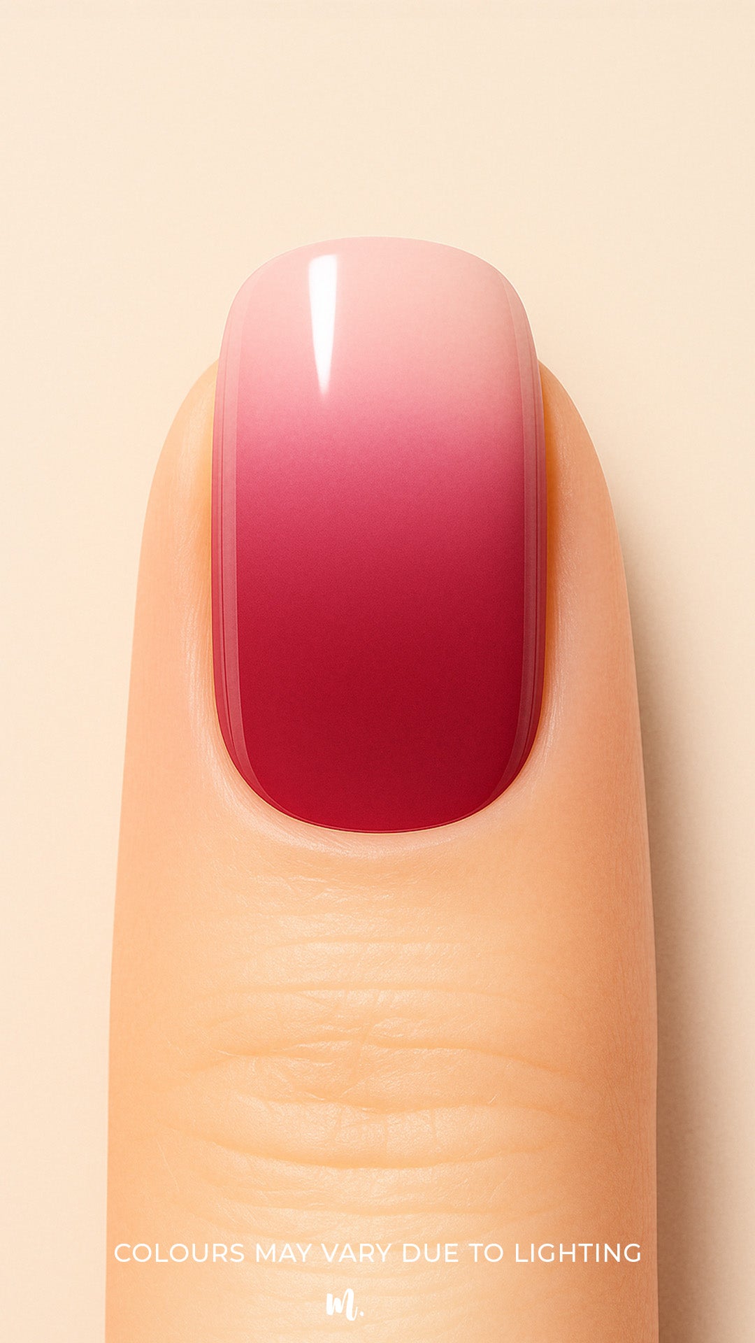 A close-up shot of a model’s finger wearing Blush Mist Ombre Nail Stickies, showcasing a smooth gradient that blends soft blush pink into a deep misty red, creating a chic and glossy ombre manicure finish – Muselot.