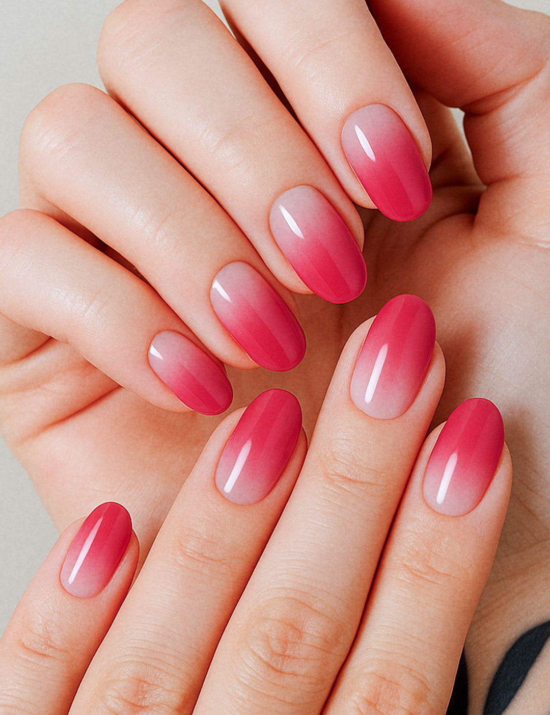 A model hand styled with Blush Mist Pink Ombre Nail Polish Stickies, featuring a seamless transition from soft blush pink at the base to a deeper rose-red tip, highlighting a glossy and elegant gradient finish that feels both subtle and striking – Muselot.