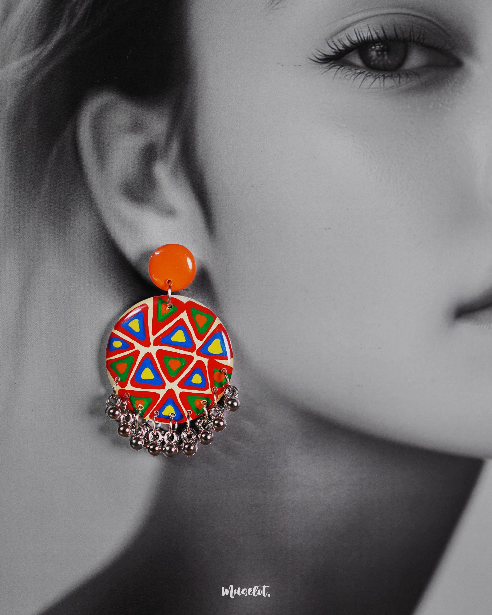 Close-up shot of a model wearing Chakardi traditional art earrings, featuring detailed craftsmanship and traditional motifs that highlight their elegant and timeless appeal — Muselot.