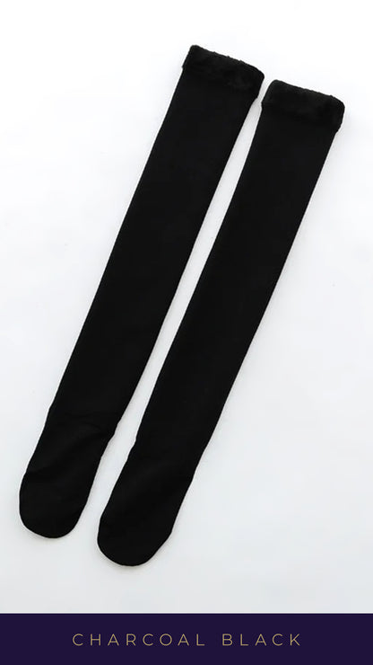 A shot of a pair of charcoal black knee-high socks against a clean white background, showcasing their sleek and stylish design. highlighting their soft, breathable fabric, making these socks both comfortable  and durable-Muselot