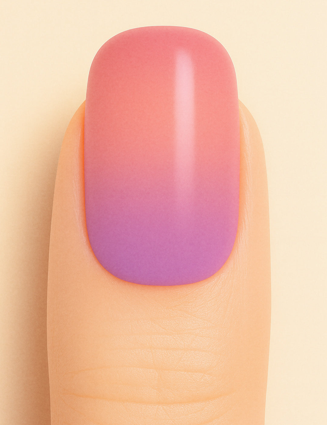 A close-up shot of a model’s finger wearing Coral Kiss Ombre Nail Stickies, showcasing a seamless transition from soft coral pink to a delicate lilac-purple tone, highlighting the smooth glossy finish and gradient charm of ombre nail art – Muselot.