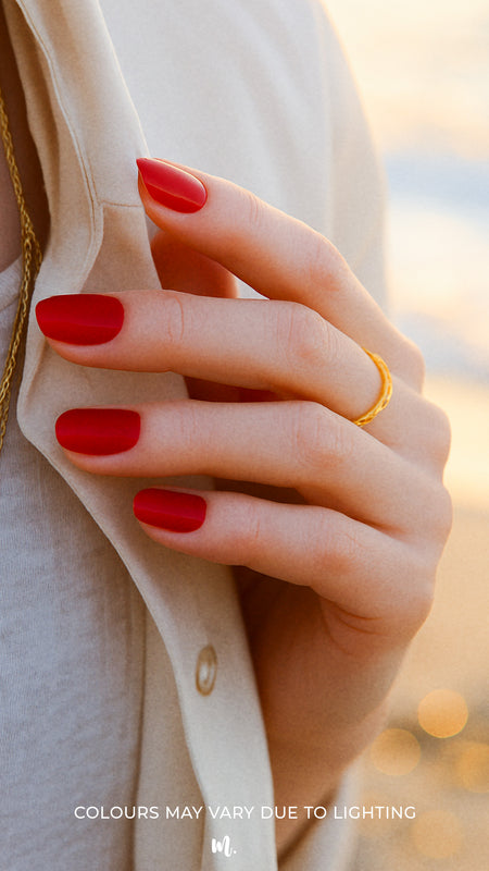 A model hand wearing Crimson Kiss Red Solid Nail Polish Stickies, featuring a striking crimson red hue with a flawless glossy finish, giving a bold and sophisticated look that stands out with timeless elegance – Muselot.