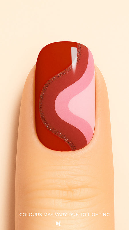 A close-up of a finger wearing Dried Rose Nail Stickies, featuring bold wavy patterns in deep red, dusty rose, and soft pink, outlined with a touch of glitter for added elegance. The design creates a retro-modern vibe, making the manicure stand out with its artistic curves and chic finish – Muselot.
