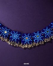 Falakzaar handcrafted necklace set styled in a natural flat lay, highlighting the vibrant blue tones and showcasing the artistic floral details and elegant thread embellishments — Muselot.