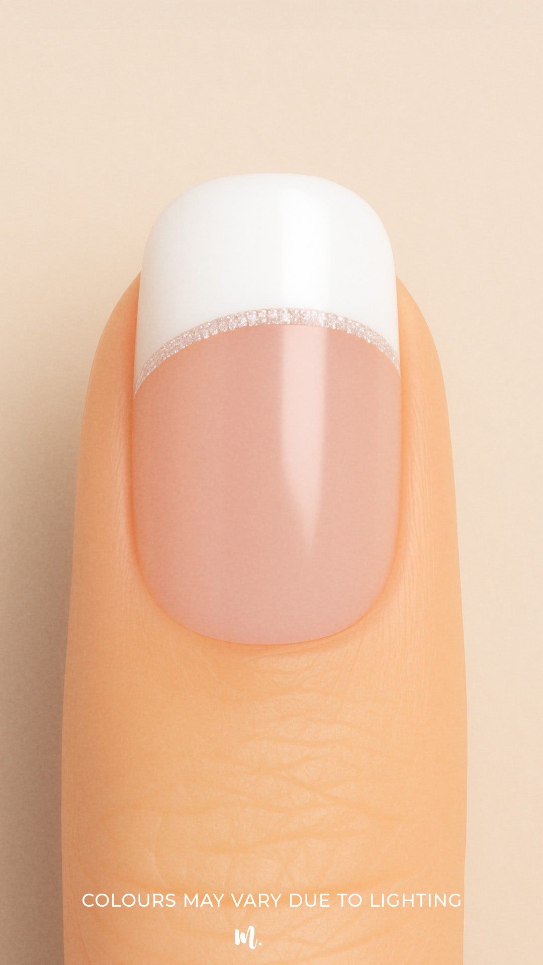 A close-up of a model’s finger featuring Frosted Charm French Tip Nail Stickies by Muselot, designed with a classic white French tip accented by a fine line of subtle glitter, giving a timeless and elegant manicure look with a glossy finish.