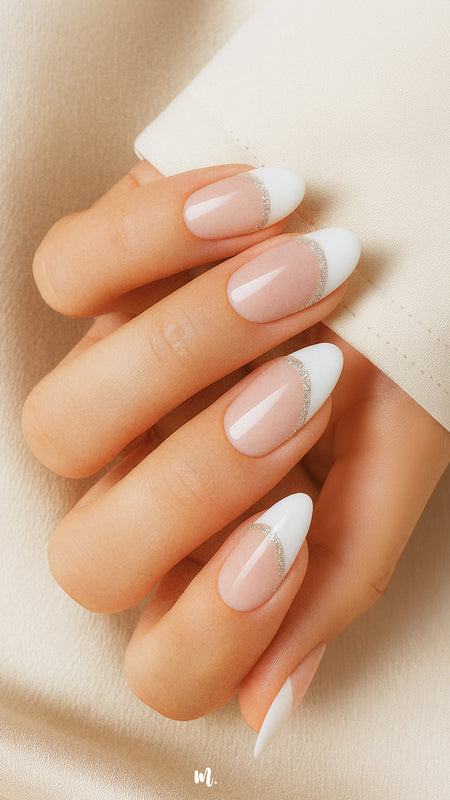 A model hand showcasing Frosted Charm French Tip Nail Stickies, featuring a soft nude base with a crisp white tip highlighted by a delicate shimmer line, capturing the timeless elegance and glossy sophistication of French manicure nail art – Muselot.