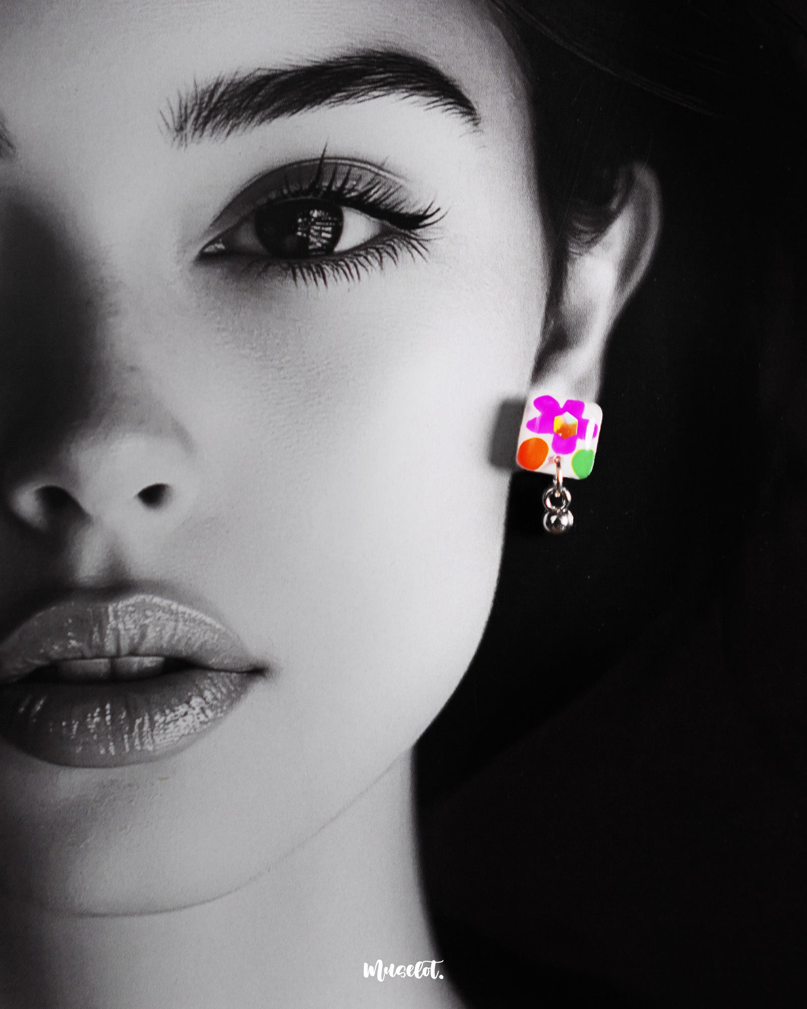 A model wears the Gulraas handmade floral stud earrings, highlighting the delicate pop of color and playful charm these tiny hand-painted blooms bring—perfect for adding a joyful accent to everyday looks — Muselot.