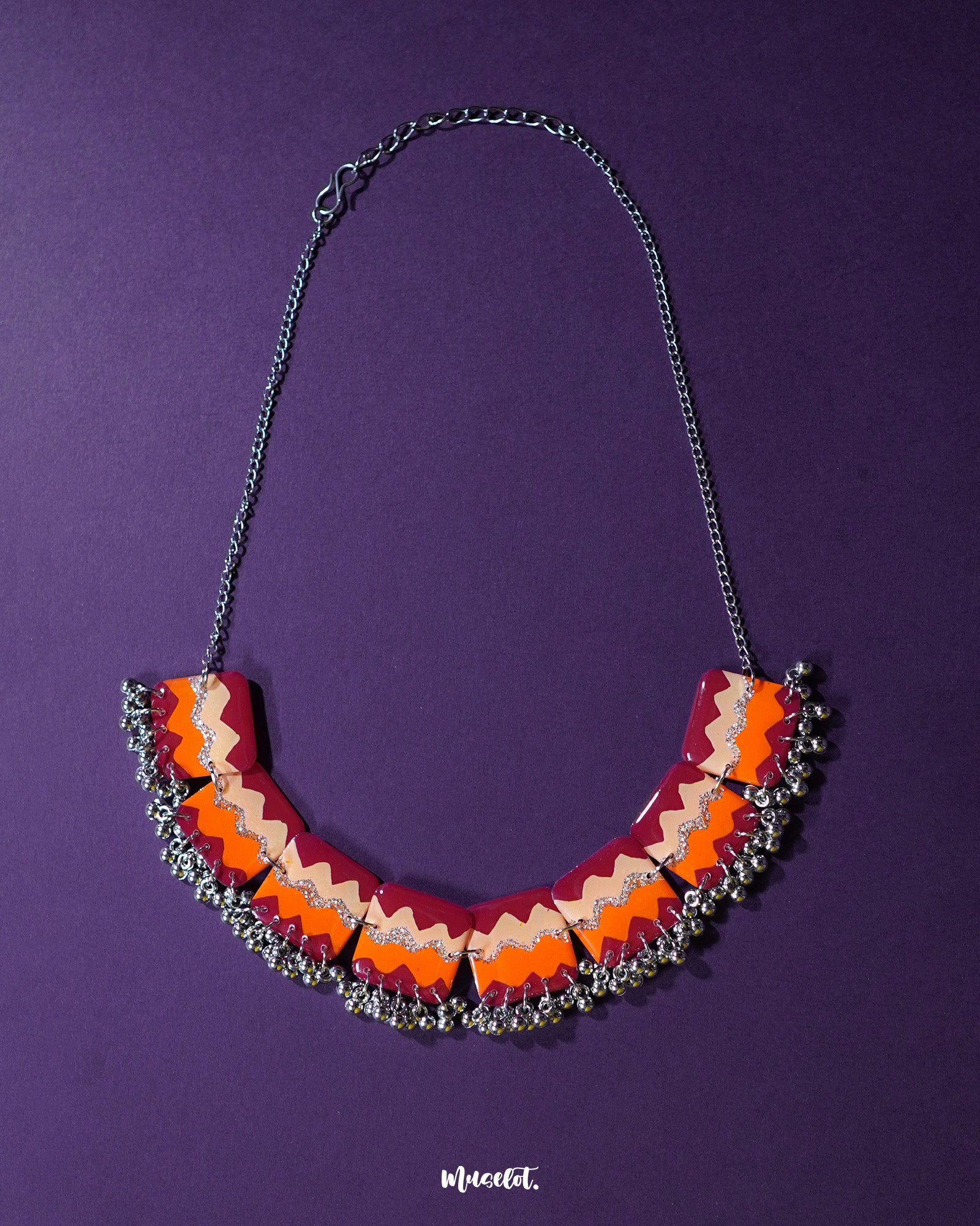 A vibrant handmade traditional necklace set displayed against a rich backdrop, showcasing intricate beadwork and detailed craftsmanship that reflects cultural heritage — Muselot.