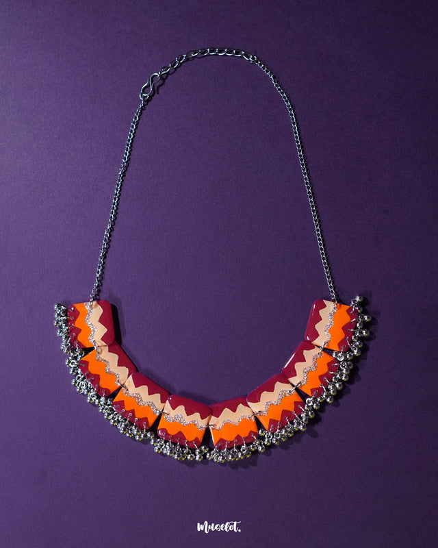 A vibrant handmade traditional necklace set displayed against a rich backdrop, showcasing intricate beadwork and detailed craftsmanship that reflects cultural heritage — Muselot.