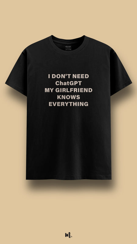 Black graphic t-shirt showcasing the “I Don’t Need ChatGPT My Girlfriend Knows Everything” statement, highlighting a playful, couple-themed attitude against a clean, minimal beige background – Muselot