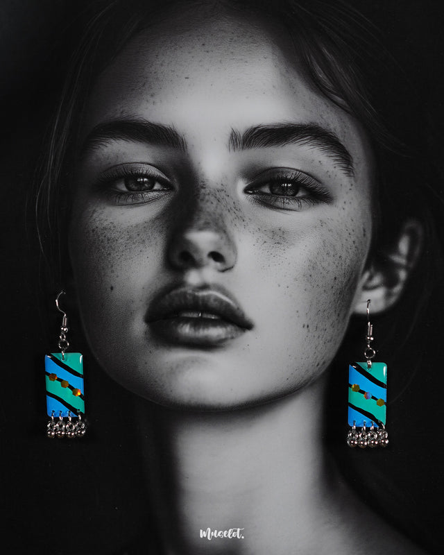A woman wearing the Jaltarang boho drop earrings, their fluid, layered design and ocean-inspired hues adding a touch of wanderlust charm to her look—Muselot.