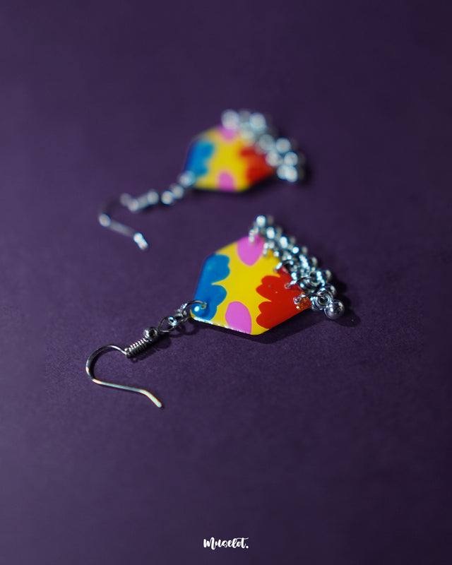 A single Jharokhe multicolor floral hook earring photographed at an angle, highlighting the intricate flower pattern and delicate ghungroo detailing that adds a playful boho touch — Muselot.