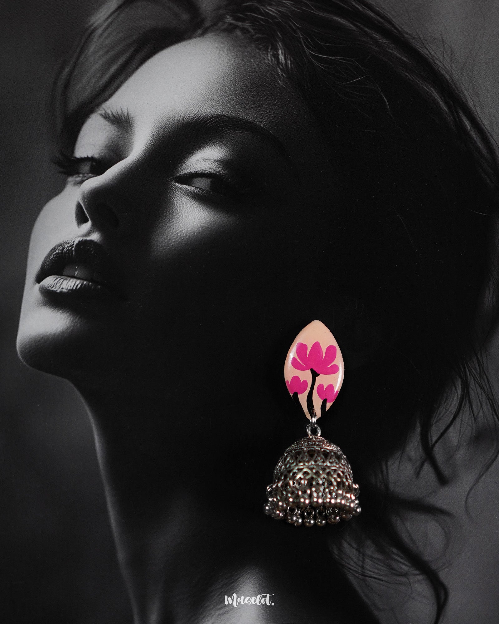 Model wearing Kumudini handcrafted jhumkas, featuring intricate traditional detailing with a graceful ethnic look, captured against a plain background to highlight the earrings’ artisanal design – Muselot.