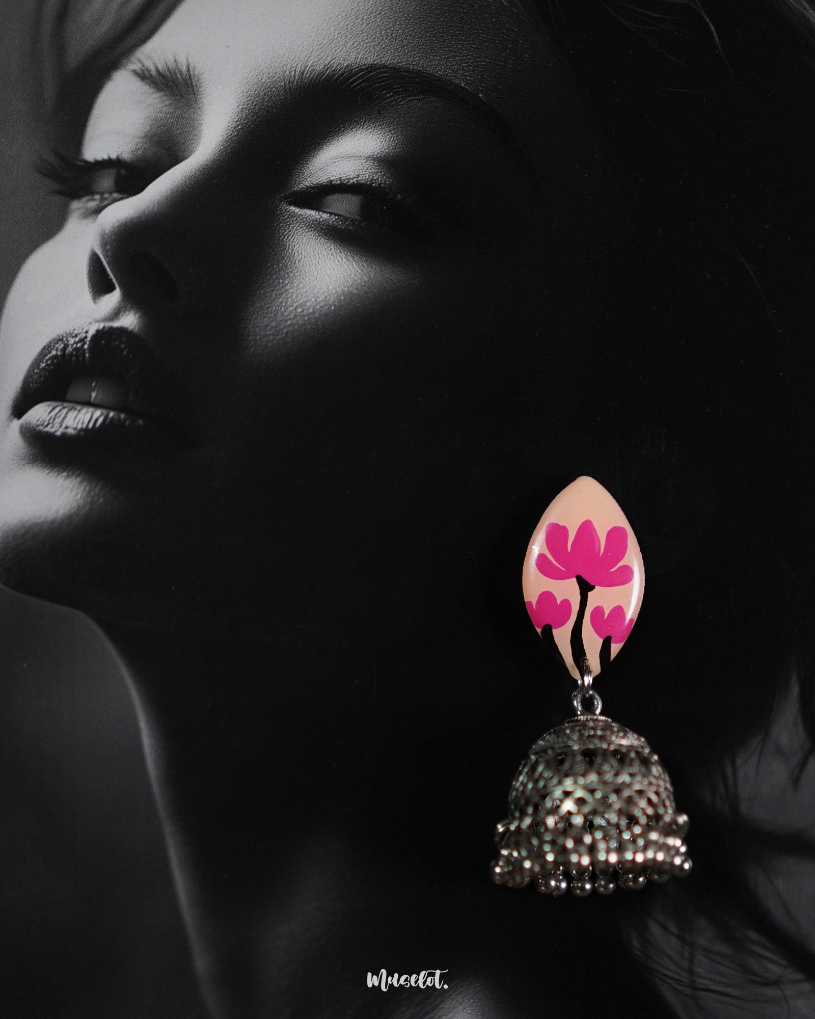 A woman wearing Kumudini handcrafted jhumkas, showcasing intricate traditional detailing with a modern ethnic touch, styled against a simple background to highlight the earrings’ craftsmanship and elegance-Muselot