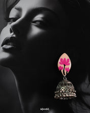 A woman wearing Kumudini handcrafted jhumkas, showcasing intricate traditional detailing with a modern ethnic touch, styled against a simple background to highlight the earrings’ craftsmanship and elegance-Muselot