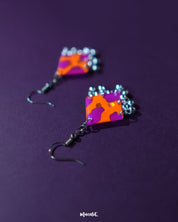 The Laalsavera hook earrings, elegantly designed and set against a bold purple background, showcase timeless beauty — Muselot.