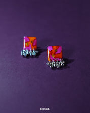 The Laalsavera stud earrings feature a timeless design, with elegant craftsmanship, beautifully highlighted against a purple backdrop — Muselot.