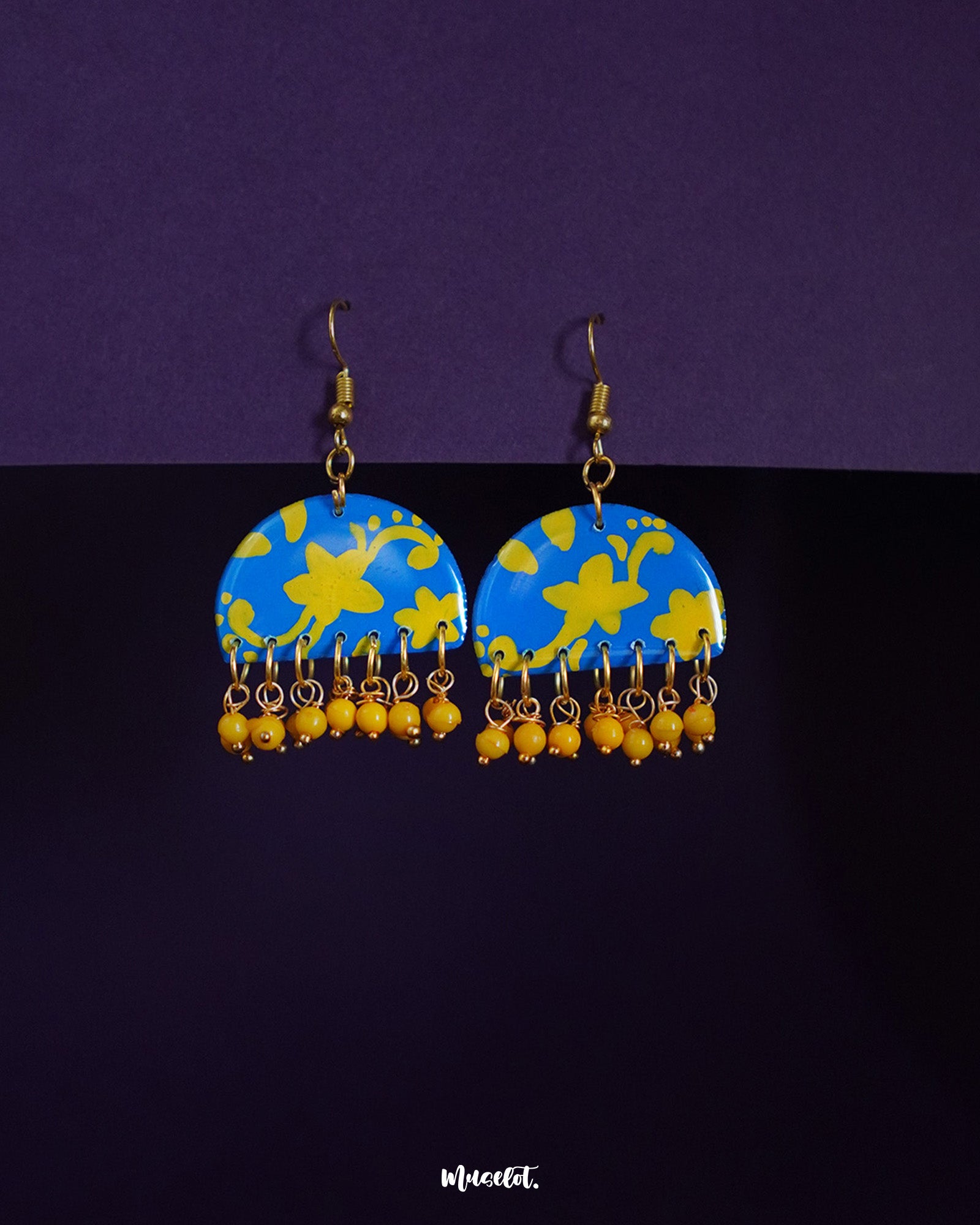 Mahrosh blue and yellow hook earrings, set against a soft background, with a perfect blend of vibrant blue and yellow hues, showcasing intricate design details that bring a playful yet elegant touch to any look — Muselot.