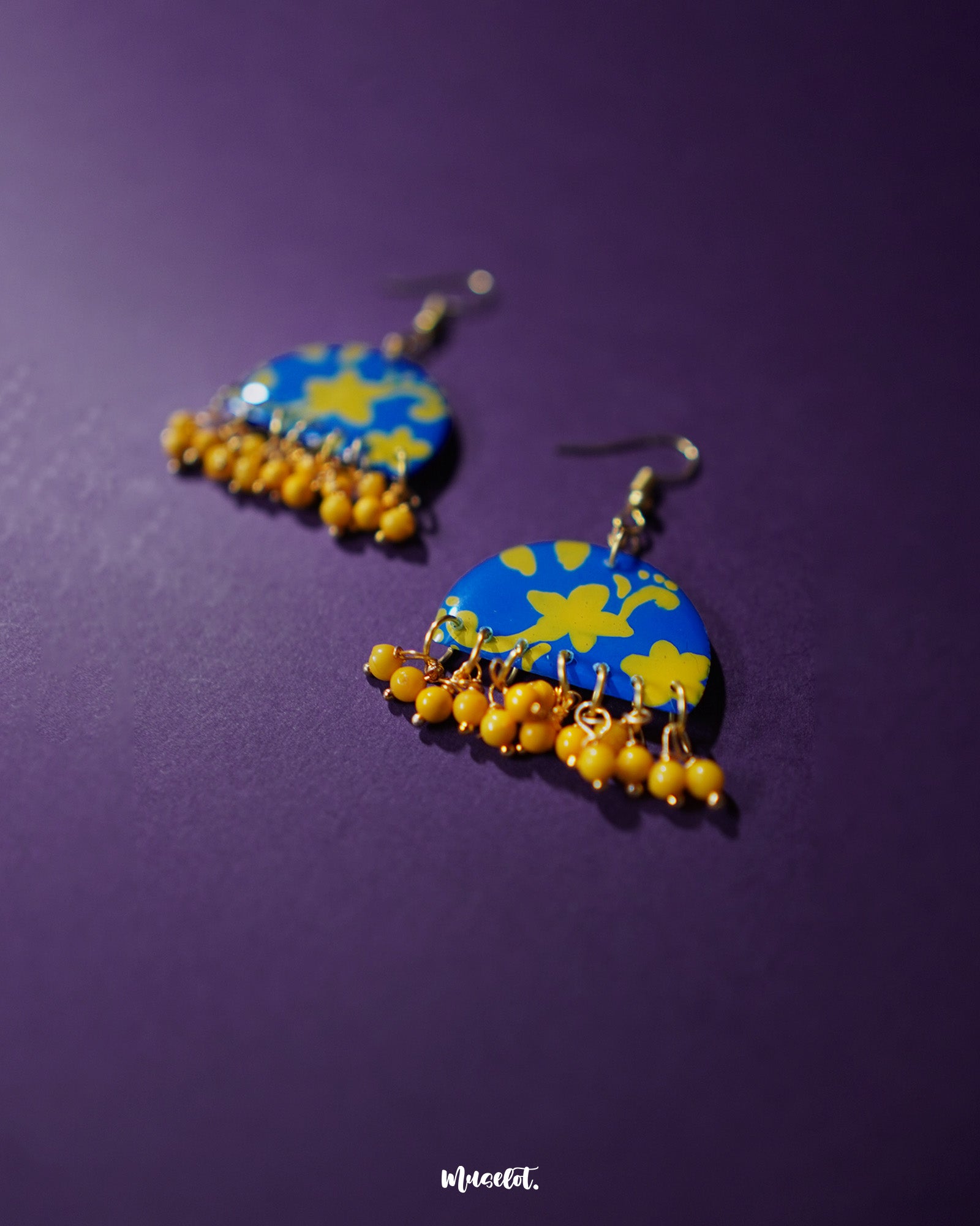 Mahrosh floral hook earrings, displayed against a soft background, with intricate floral detailing and a delicate design that brings out a perfect balance of elegance and natural beauty — Muselot.