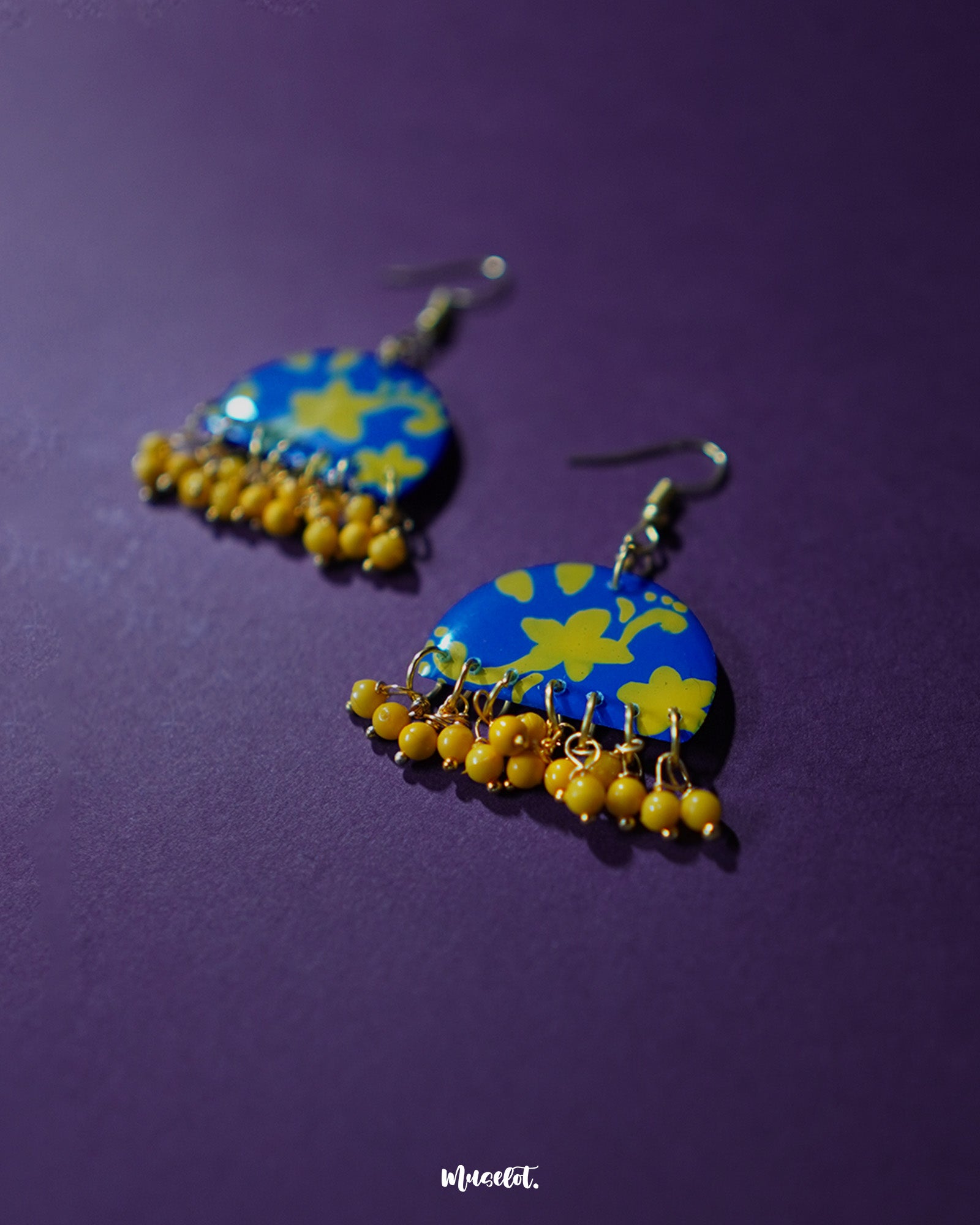 Mahrosh floral hook earrings, showcased against a subtle backdrop, featuring intricate floral patterns and a refined design that exudes timeless elegance and nature-inspired charm — Muselot.